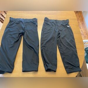two pairs of nike softball pants